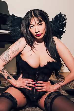 Sabinas black lace modulates under pianos slow rhythm, tattoos glisten